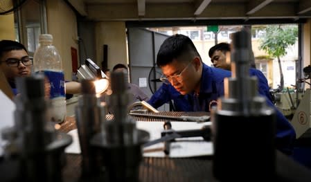 Students practise at a lab of an industrial vocational training college in Hanoi