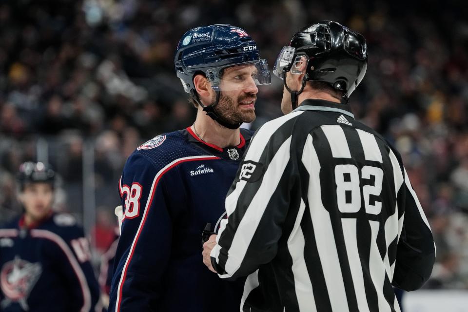 Nov 27, 2023; Columbus, Ohio, USA; Columbus Blue Jackets center Boone Jenner (38) talks to linesman Ryan Galloway (82) after being thrown out of the face off circle during the third period of the NHL game against the Boston Bruins at Nationwide Arena. The Blue Jackets won 5-2.