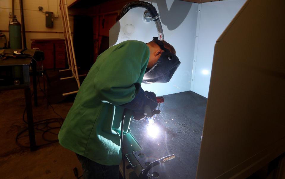 Ayden Proseus, a 9th-grader at Marion Jr/Sr High School, learns stick welding during class. Budget changes could put some classes at risk for upcoming school years.