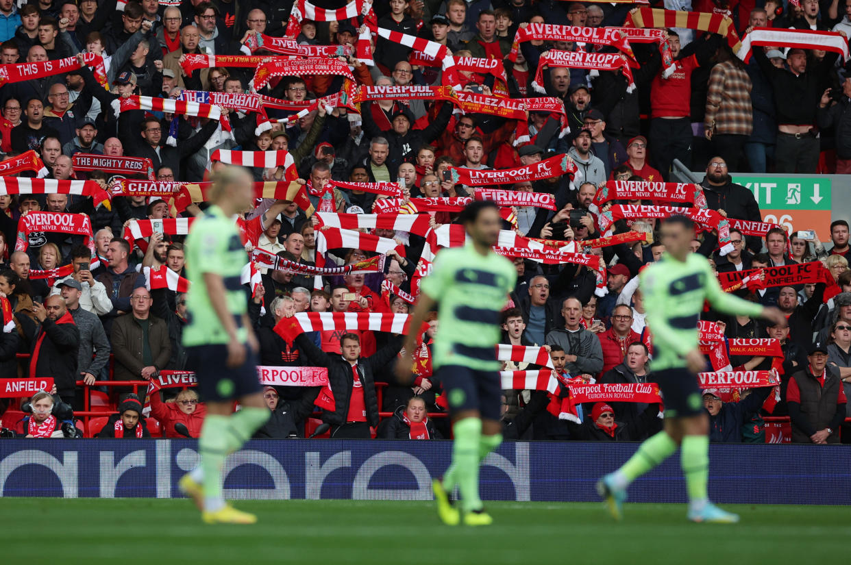 Liverpool fans displaying their team scarves during their English Premier League clash against Manchester City at Anfield.