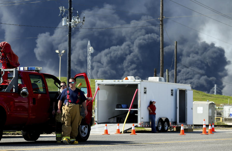 Firefighters arrive at the site where the Intercontinental Terminals Company petrochemical fire reignited, Friday, March 22, 2019, in Deer Park, Texas. The efforts to clean up a Texas industrial plant that burned for several days this week were hamstrung Friday by a briefly reignited fire and a breach that led to chemicals spilling into the nearby Houston Ship Channel. (Godofredo A. Vasquez/Houston Chronicle via AP)