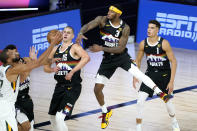 Denver Nuggets' Torrey Craig (3) tries to swat the ball away as Utah Jazz's Rudy Gobert, left, competes for a rebound against Nuggets' Nikola Jokic (15) during the first half of an NBA basketball first round playoff game, Monday, Aug. 17, 2020, in Lake Buena Vista, Fla. Nuggets' Michael Porter Jr. (1) looks on. (AP Photo/Ashley Landis, Pool)