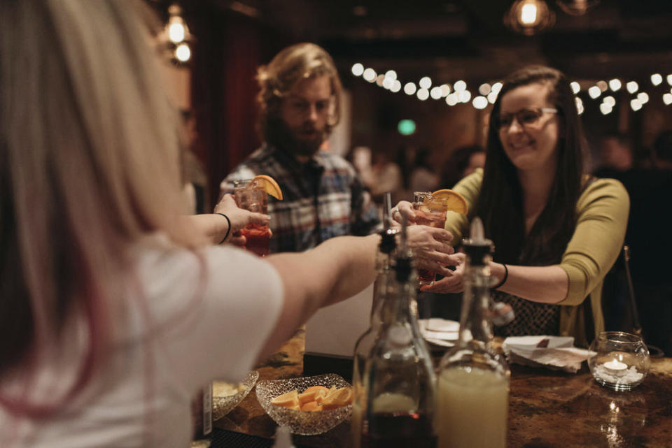 In this Jan. 17, 2019 photo, a bartender serves patrons Rae of Sunshine mocktails at Sans Bar pop up bar at The Factory Luxe in Seattle, a Marnie Rae launch party for National Mocktail Week. (Saleina Marie Photography via AP)