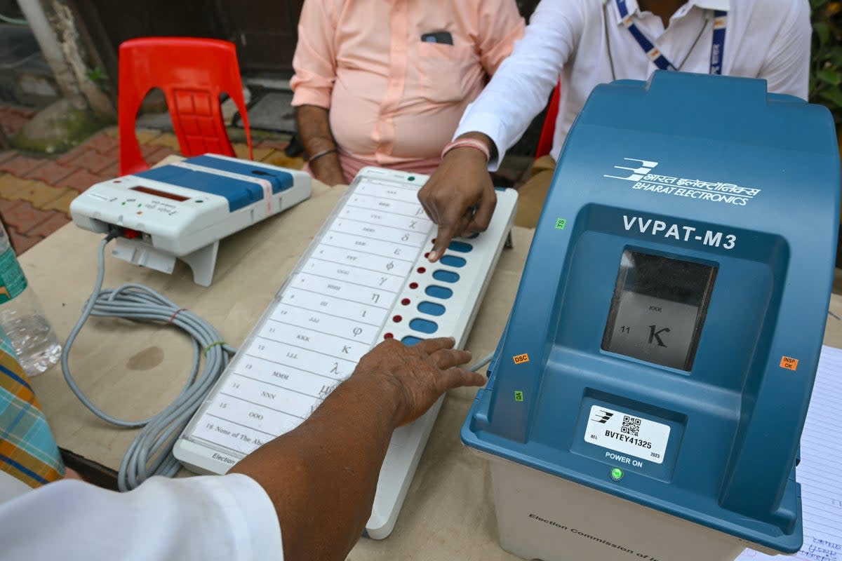 Indian election official (R) demonstrates the use of the Voter Verifiable Paper Audit Trail  (AFP via Getty Images)