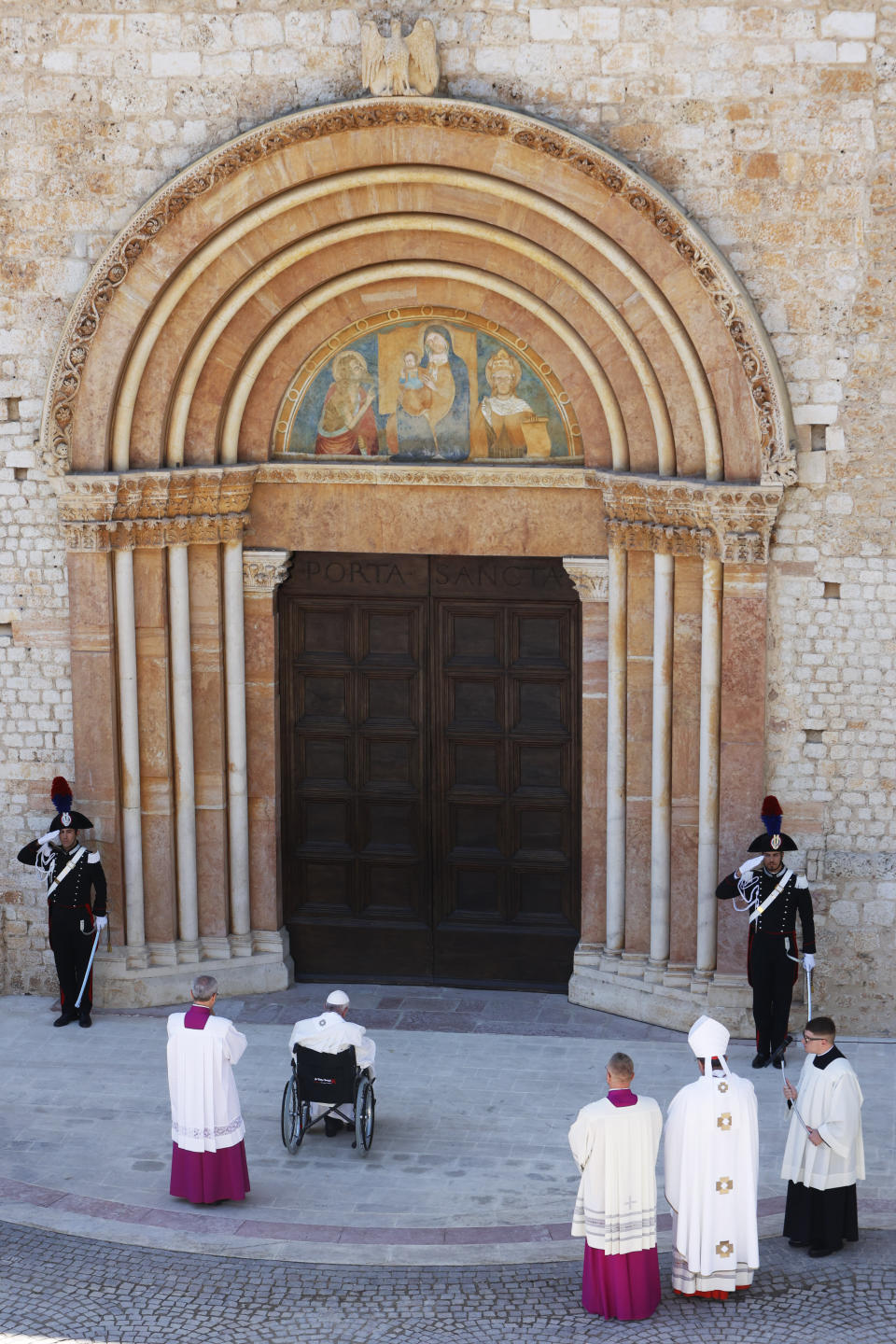 Pope Francis arrives to open the Holy Door of St. Mary in Collemaggio Basilica and start the jubilee of forgiveness, in L'Aquila, central Italy, Sunday, Aug. 28, 2022. Pope Francis will be the first pope since Celestine V to open this Holy Door, the first in history, established with the Bull of Forgiveness of 29 September 1294 by Pope Celestine V. (AP Photo/Riccardo De Luca)