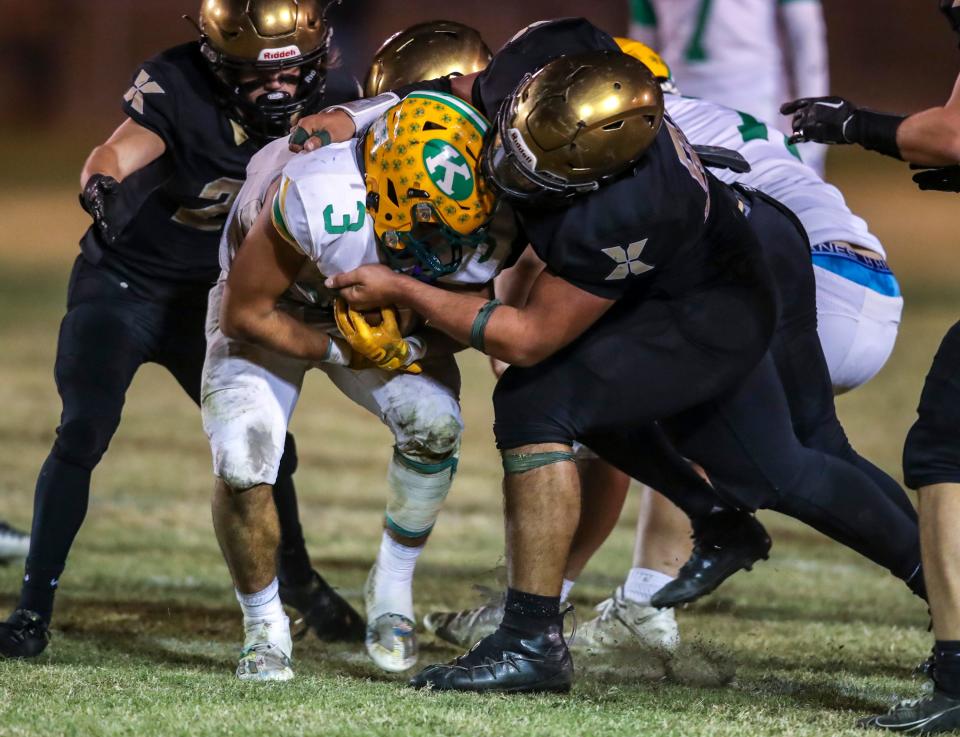 Xavier Prep's John Martino (88) tackles Kennedy's Rider Street (3) during the fourth quarter of their second-round playoff game at Xavier College Preparatory High School in Palm Desert, Calif., Friday, Nov. 10, 2023.