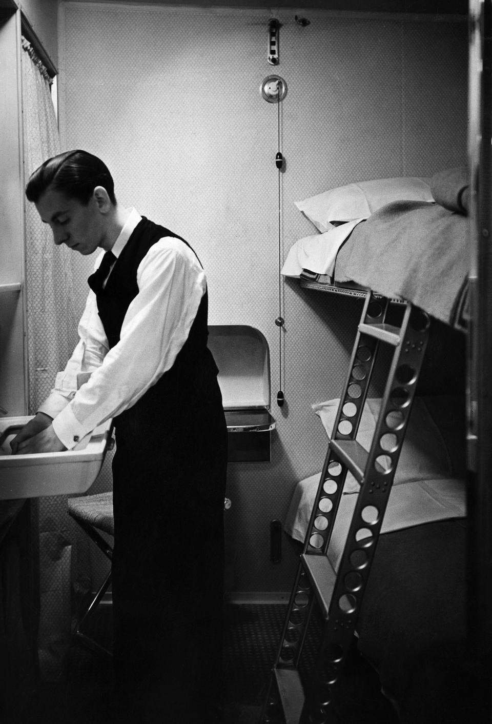 <p>A passenger is seen in his cabin aboard the Hindenburg in 1936. (Heinrich Hoffmann/ullstein bild via Getty Images) </p>