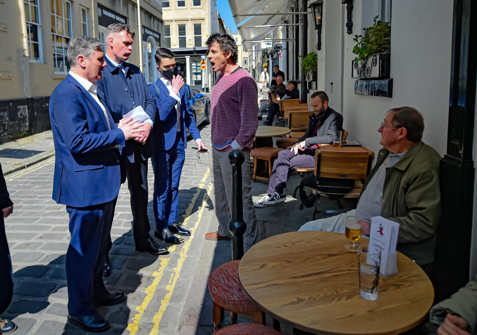 Labour leader Sir Keir Starmer (left) listens to Rod Humphris (centre), landlord of The Raven pub in Bath, as he shouts how disappointed he is with him and the Labour party during the pandemic, consequently asking him to leave and banning him from the pub,. Mr Starmer was visiting the city to support West of England metro mayoral candidate Dan Norris and mark Labour's launch of an independent Commission to rebuild Britain's high streets. Picture date: Monday April 19, 2021.