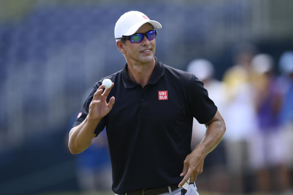 Adam Scott, of Australia, tips his ball to the gallery after finishing his round on the 18th green during the first round of the BMW Championship golf tournament at Wilmington Country Club, Thursday, Aug. 18, 2022, in Wilmington, Del. (AP Photo/Nick Wass)