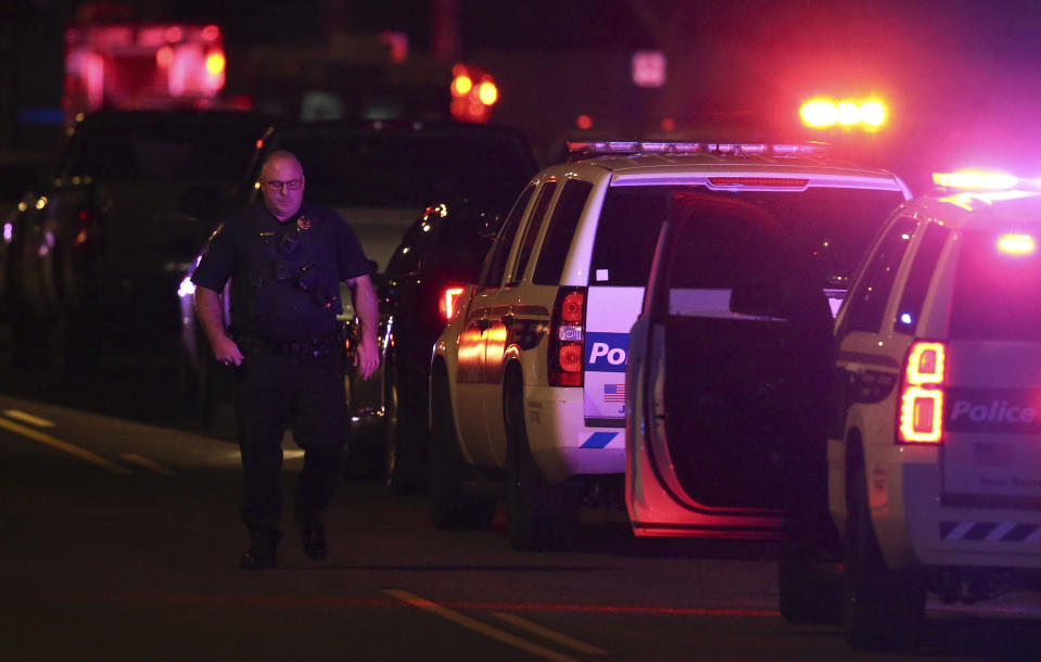 A Phoenix Police officer arrives on the scene of a shooting in Phoenix, Ariz., Sunday, March 29, 2020. At least three Phoenix police officers were shot Sunday night on the city's north side, authorities said. (AP Photo/Ross D. Franklin)