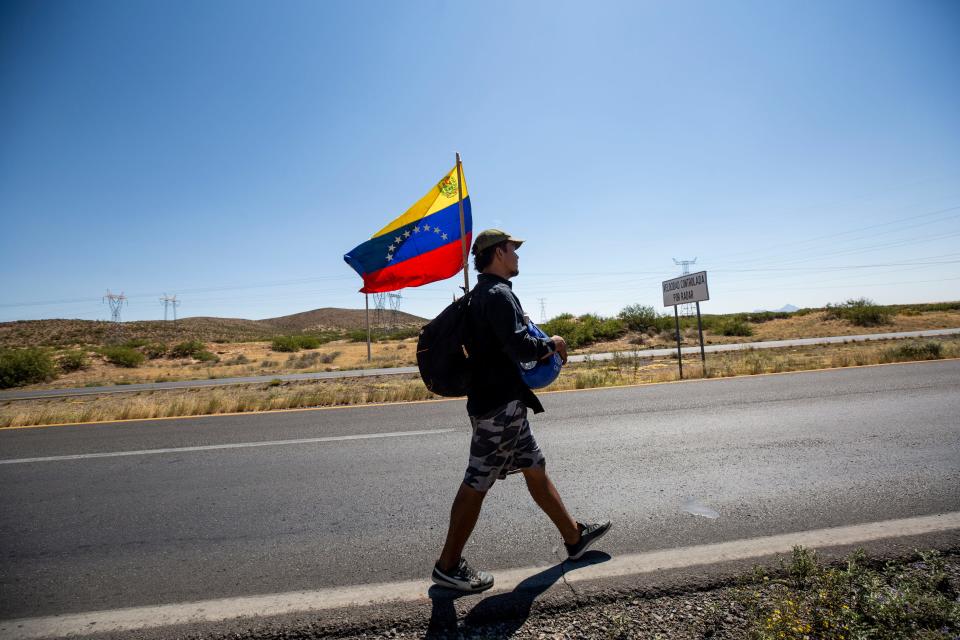 A migrant from Venezuela walks south on a highway heading to Chihuahua, Mexico after deciding to head back home after an unsuccessful attempt to enter the U.S. to seek asylum The migrant did not have money to return home and was determined to walk back to South America.