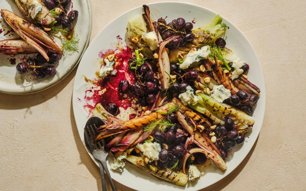 overhead view of a roast grape, bitter leaf, fennel and Gorgonzola salad served on a white plate