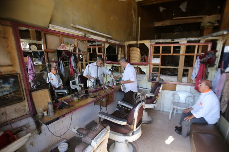 Barber Mohammed Zakaria, 65, in his shop in Aleppo