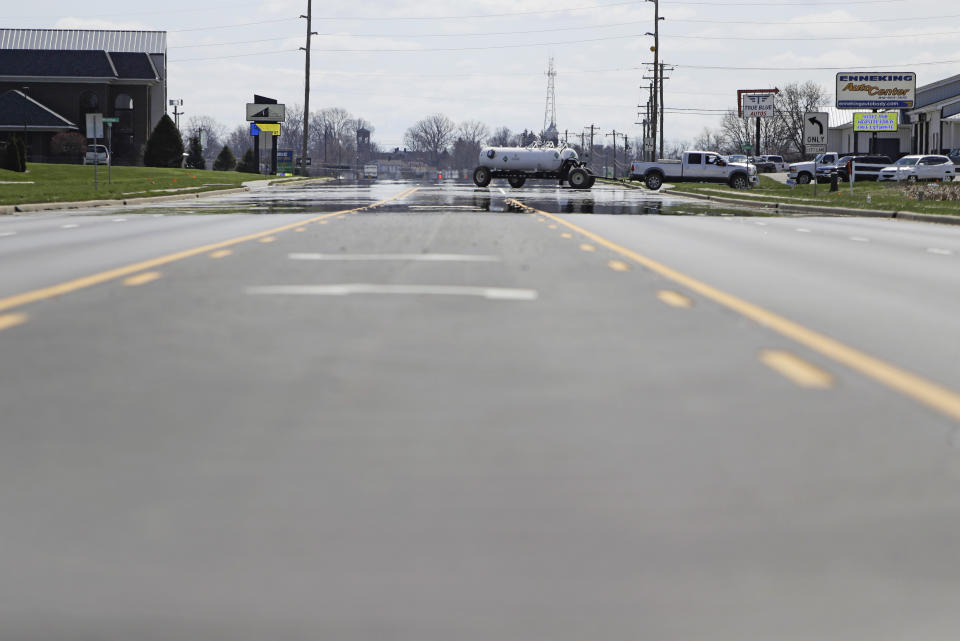 A truck pulls into a parking lot, Thursday, April 2, 2020, in Greensburg, Ind. County officials imposed a ban on nonessential travel and ordered all restaurants closed, including for take-out orders, in steps going beyond the Indiana governor's stay-at-home order that took effect March 25. Three southeast Indiana counties have among the highest per-capita coronavirus infection rates in the country. (AP Photo/Darron Cummings)