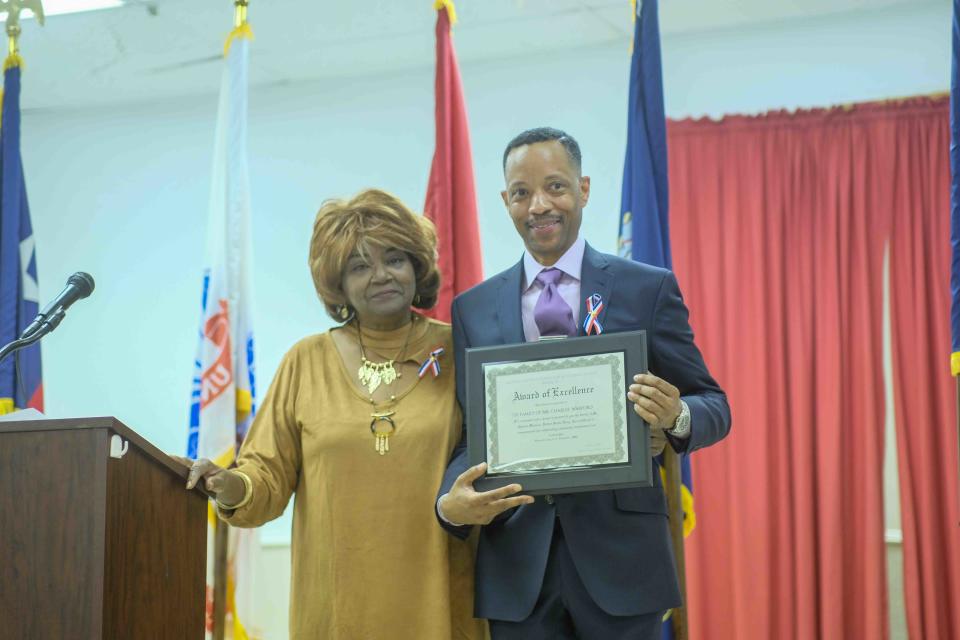 Bradwick Lamont Warford Coffer accepts the posthumous honor for his grandfather, the late  World War II veteran Vernon Conner on Saturday during the Veteran's Honor Banquet held at the Amarillo United Citizen's Forum.