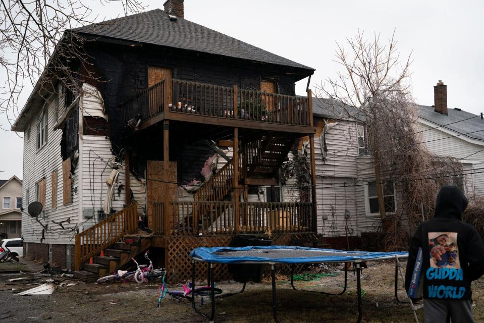 Daquan Davis, 28, walks behind the duplex he rents with his fiancé Janet Kelly, along with four children, on Beniteau Street in Detroit on Monday, Feb. 27, 2023. The family lost their home and belongings in a house fire accidentally caused by downstairs tenants.