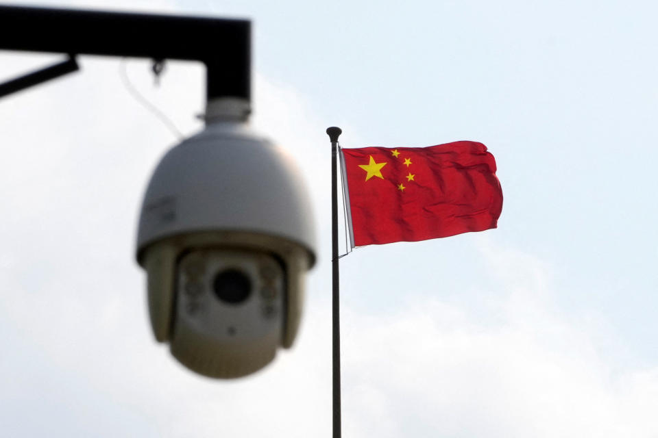 A surveillance camera is seen near a Chinese flag in Shanghai, China August 2, 2022. REUTERS/Aly Song