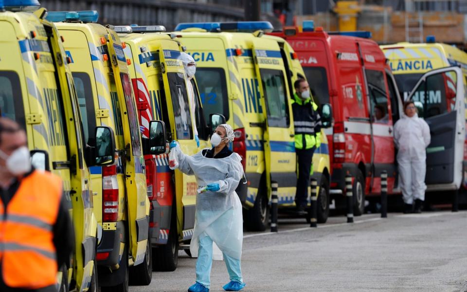 More than a dozen ambulances queue waiting to hand over their COVID-19 patients to medics at the Santa Maria hospital in Lisbon, Friday, Jan. 22, 2021. Portugal's COVID-19 surge is continuing unabated, with a new record of daily deaths, hospitalizations and patients in intensive care. - AP Photo/Armando Franca