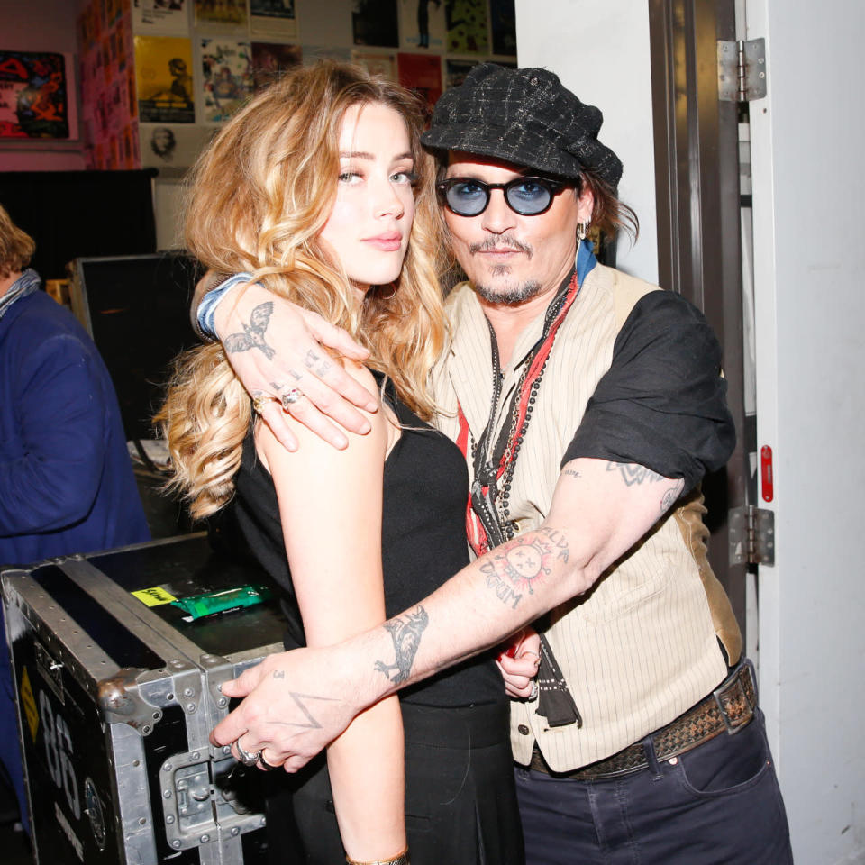 Amber Heard and Johnny Depp in an awkward embrace at Stella McCartney’s autumn 2016 show at Amoeba Music in Los Angeles.