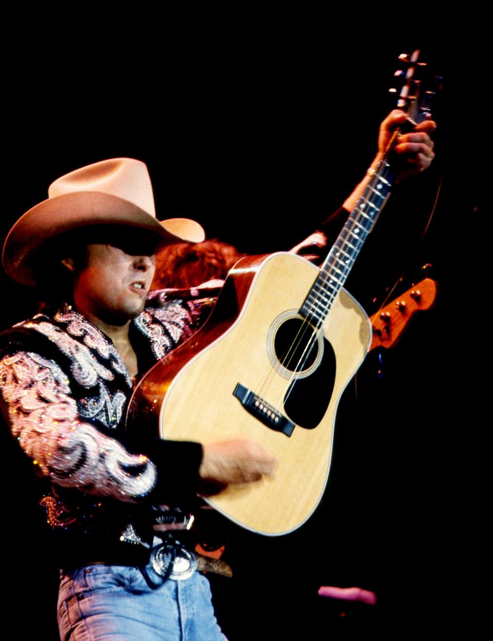 Honky-tonk champion Dwight Yoakam finishes up one of his hit songs for nearly 10,000 fans at Starwood Amphitheatre on Aug. 19, 1989. Yoakam, Clint Black and headliners The Judds kept the fans entertained.