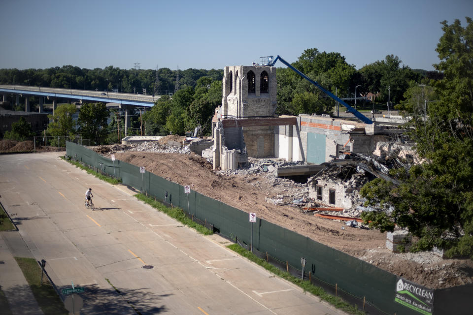 A church is demolished where the oil services firm U.S. Ventures announced it would build a new headquarters employing 500 people on a city bluff in Appleton, Wis., Aug. 19, 2020. Then the coronavirus pandemic struck. The status of the U.S. Ventures headquarters is now uncertain, but even as the old church on the bluff gets demolished for a groundbreaking the headquarters certainly won't open as announced in 2022. (AP Photo/David Goldman)