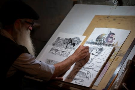 Michael Netzer, an American comics artist formerly named Mike Nasser, sketches at his attic studio in his home in the Jewish settlement of Ofra in the Israeli-occupied West Bank