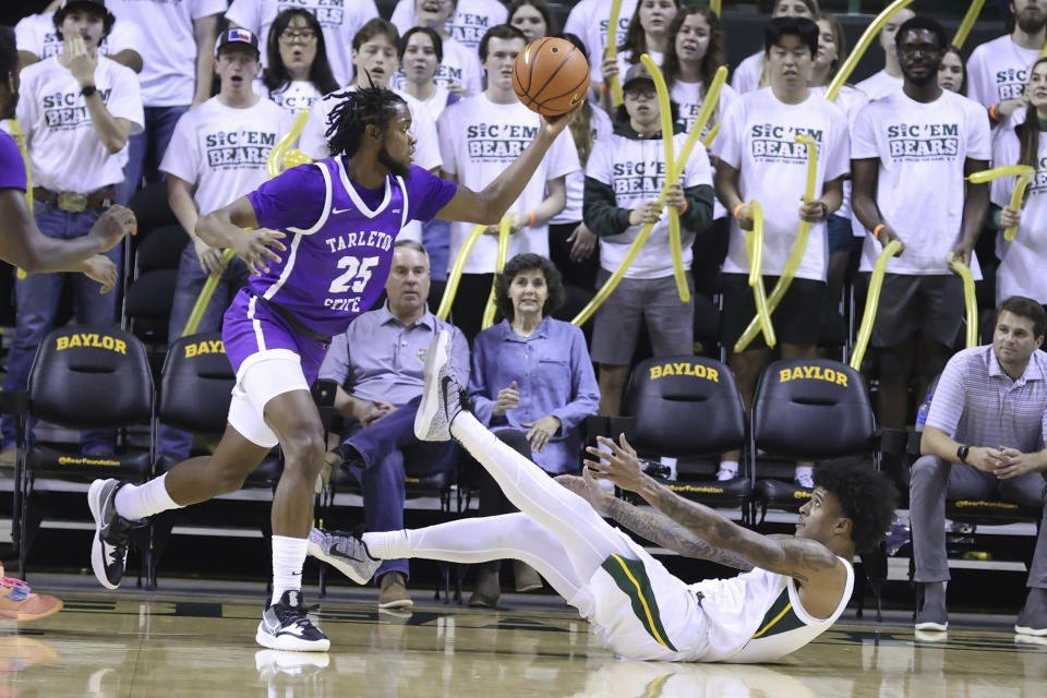 Tarleton State forward Coreyoun Rushin (25) grabs a loose rebound over Baylor forward Jalen Bridges (11) in the first half of an NCAA college basketball game, Tuesday, Dec. 6, 2022, in Waco, Texas. (AP Photo/Rod Aydelotte)