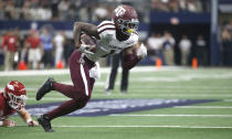 Texas A&M wide receiver Quartney Davis (1) takes a pass to the end zone past Arkansas linebacker Hayden Henry (27) during the first half of an NCAA college football game Saturday, Sept. 28, 2019, in Arlington, Texas. (AP Photo/Ron Jenkins)