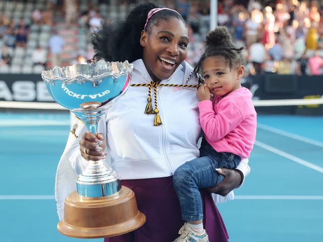 <p>MICHAEL BRADLEY/AFP/Getty</p> Serena Williams and Alexis Olympia during the Auckland Classic tennis tournament in 2020