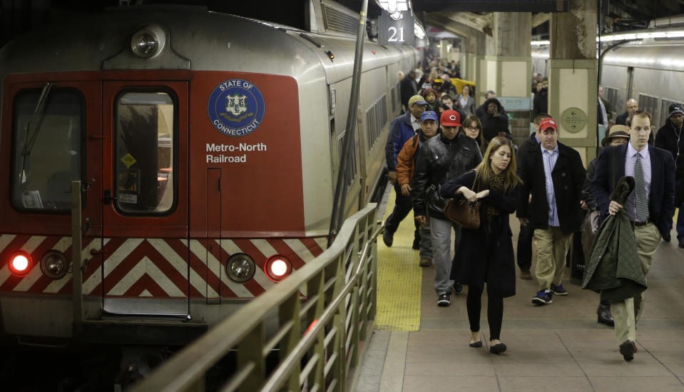 Passengers disembark from a Metro-North Railroad car after it pulled into Grand Central Terminal in New York, Wednesday, Jan. 9, 2013. The landmark train station, one of the country's most famous examples of Beaux Arts architecture, is celebrating it's 100th anniversary February 1. (AP Photo/Kathy Willens)