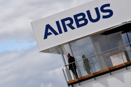 FILE PHOTO: A man stands at an Airbus trade pavilion at Farnborough International Airshow in Farnborough, Britain