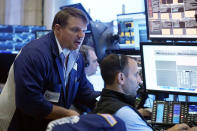 Trader Michael Milano, left, works with colleagues on the floor of the New York Stock Exchange, Friday, Aug. 25, 2023. (AP Photo/Richard Drew)