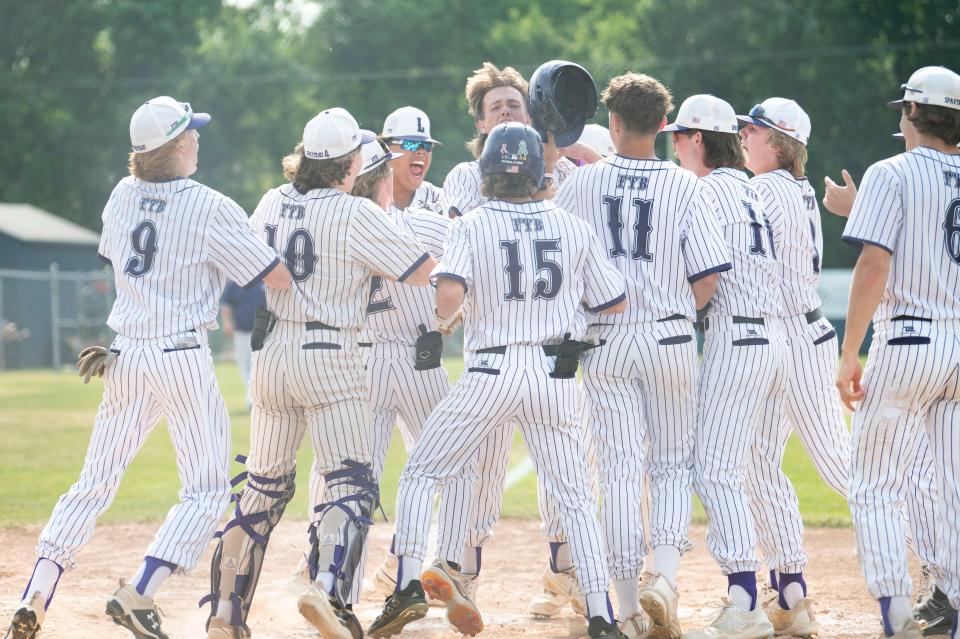 Lakeview players celebrate a home run by senior Cade Oxley during a regional playoff game against Okemos at DeWitt High School on Wednesday, June 7, 2023.
