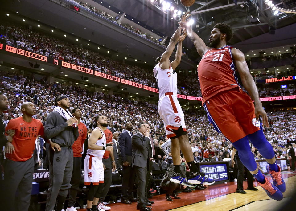 FILE - In this Sunday, May 12, 2019, file photo, Philadelphia 76ers center Joel Embiid (21) fails to stop Toronto Raptors forward Kawhi Leonard's (2) last-second basket during the second half of an NBA Eastern Conference semifinal basketball game in Toronto. (Frank Gunn/The Canadian Press via AP, File)