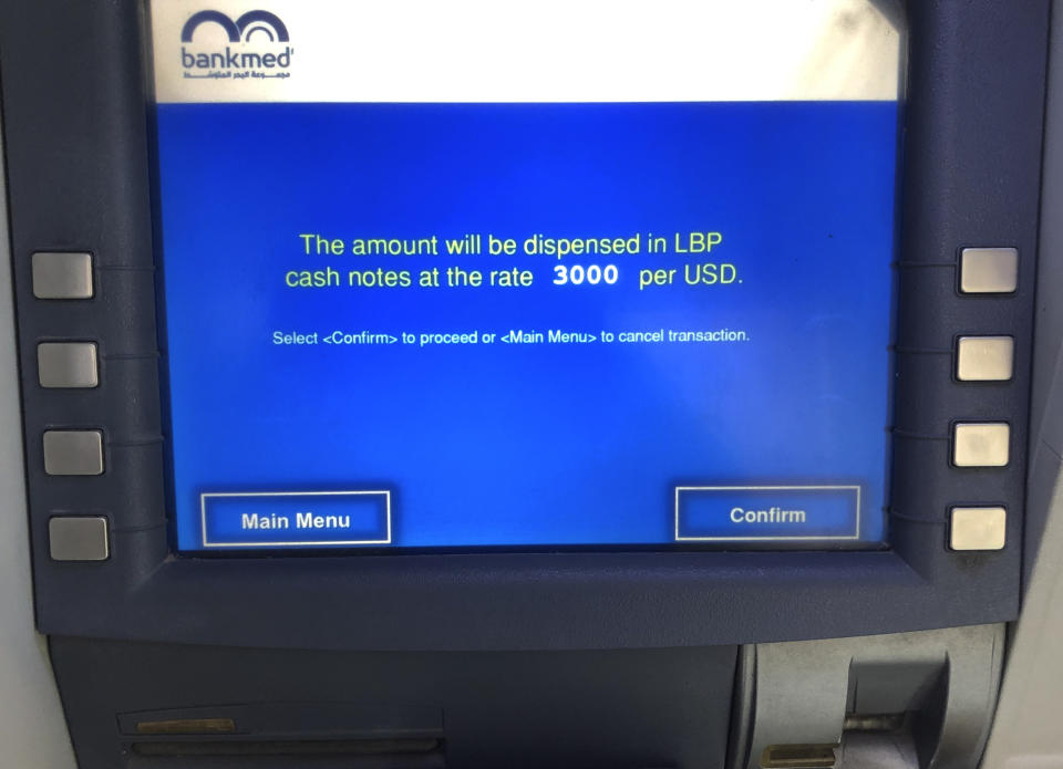 A bank ATM machine shows a message that announces that only Lebanese pounds can be dispensed even if the account is in dollars at the official bank rate, in Beirut, Lebanon, June 25, 2020. Lebanon's financial meltdown has thrown its people into a frantic search for dollars as the local currency's value evaporates. Many try to rescue their dollars trapped in bank accounts frozen by the government. Purchases of real estate have shot up as Lebanese search for places to save their wealth from spiraling exchange rates. (AP Photo/Hussein Malla)