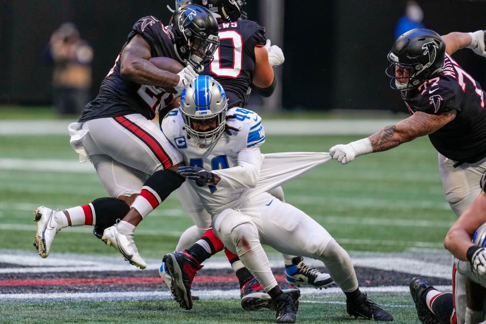 Falcons running back Mike Davis is hit in the air by Lions inside linebacker Jalen Reeves-Maybin during the second half of the Lions' 20-16 loss on Sunday, Dec. 26, 2021, in Atlanta.