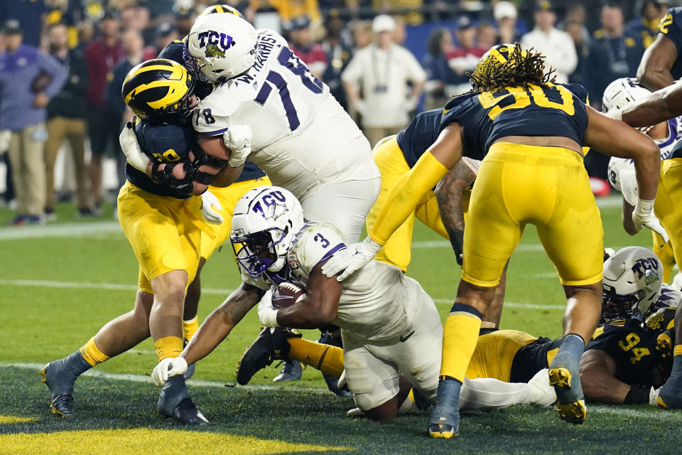 TCU running back Emari Demercado (3) scores a touchdown against Michigan during the second half of the Fiesta Bowl NCAA college football semifinal playoff game, Saturday, Dec. 31, 2022, in Glendale, Ariz. (AP Photo/Ross D. Franklin)