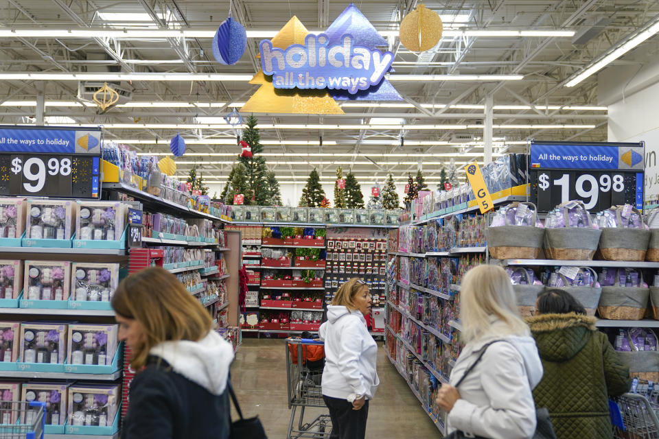 People shop at a Walmart in Secaucus, N.J., Tuesday, Nov. 22, 2022. More than two and a half years into the pandemic, many businesses haven't been able to resume the same hours of operations or services as they continue to grapple with worker shortages. (AP Photo/Seth Wenig, File)