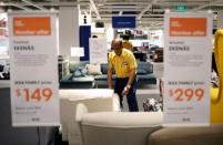 Kadir Muhaideen, 67, arranges sofas at Ikea in Singapore December 14, 2018. REUTERS/Edgar Su/Files