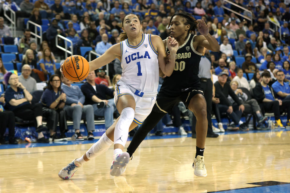 LOS ANGELES, CALIFORNIA - FEBRUARY 26: Kiki Rice #1 of the UCLA Bruins drives around Jaylyn Sherrod #00 of the Colorado Buffaloes during the second half of a game at UCLA Pauley Pavilion on February 26, 2024 in Los Angeles, California. (Photo by Katharine Lotze/Getty Images)