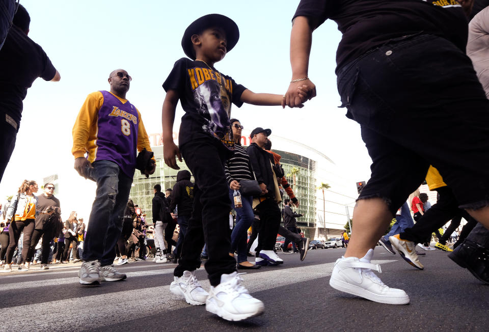 Fans leave the Staples Center after a public memorial for former Los Angeles Lakers star Kobe Bryant and his daughter, Gianna, in Los Angeles, Monday, Feb. 24, 2020. (AP Photo/Ringo H.W. Chiu)