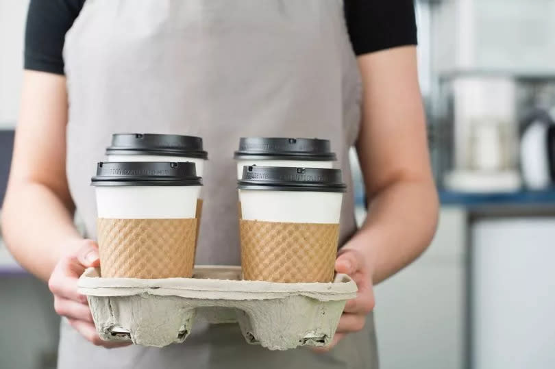 a barista serving coffee