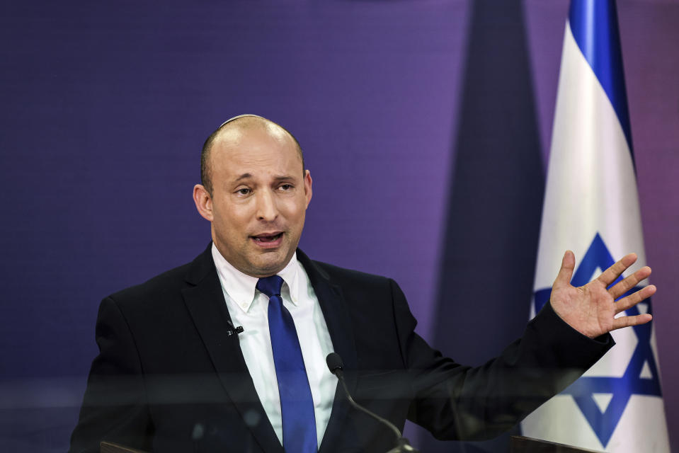 FILE - In this June 6, 2021, file photo, Naftali Bennett, Israeli parliament member from the Yamina party, gives a statement at the Knesset, Israel's parliament, in Jerusalem. If all goes according to plan, Israel will swear in a new government on Sunday, June 13, putting an end to Prime Minister Benjamin Netanyahu’s record 12-year rule and a political crisis that led to four elections in less than two years. The next government, which will be led by the ultranationalist Bennett, has vowed to chart a new course aimed at healing the country’s divisions and restoring a sense of normalcy. (Menahem Kahana/Pool via AP, File)