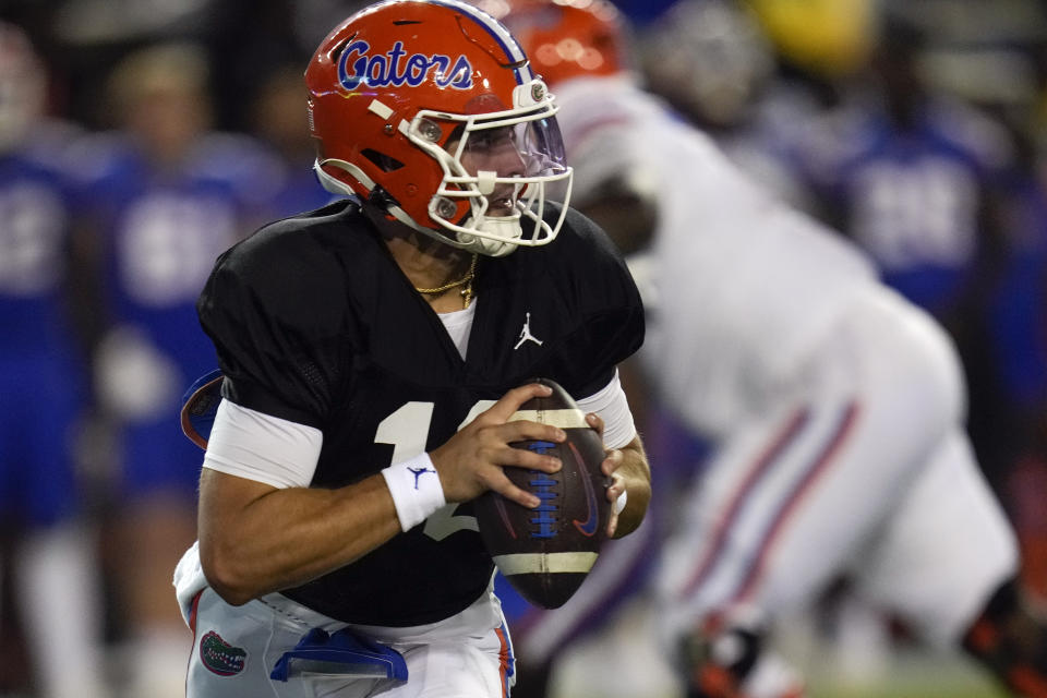 Florida quarterback Jack Miller III scrambles as he looks for a receiver during the second half of the NCAA college football team's annual Orange and Blue spring game, Thursday, April 13, 2023, in Gainesville, Fla. (AP Photo/John Raoux)