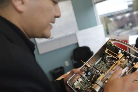 Cybersecurity researcher Billy Rios looks over an infusion pump, which controls the flow of intravenous drugs into hospital patients, in Redwood City, California October 10, 2014. REUTERS/Robert Galbraith