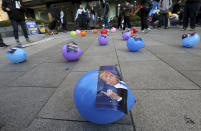 <p>Balloons attached pictures of the President Donald Trump are displayed during a rally to oppose his planned visit near the U.S. Embassy in Seoul, South Korea, Saturday, Nov. 4, 2017. (Photo: Ahn Young-joon/AP) </p>