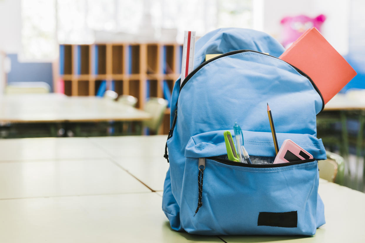A blue backpack filled with supplies for the back to school season. (Photo via Getty Images)