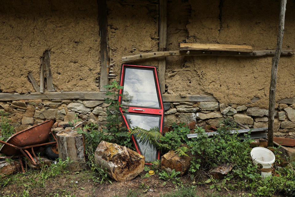 <p>A tractor door is seen in front of an abandoned house in the empty village of Repusnica, near the southeastern town of Knjazevac, Serbia, Aug. 15, 2017. (Photo: Marko Djurica/Reuters) </p>