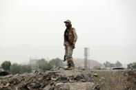 A Huthi militant stands guard at the site of an air-strike by the Saudi-led coalition, in the capital Sanaa on July 14, 2015