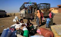 FILE PHOTO: Ethiopians who fled the ongoing fighting in Tigray region, prepare to board a courtesy trucks in Hamdayet village on the Sudan-Ethiopia border, eastern Kassala state